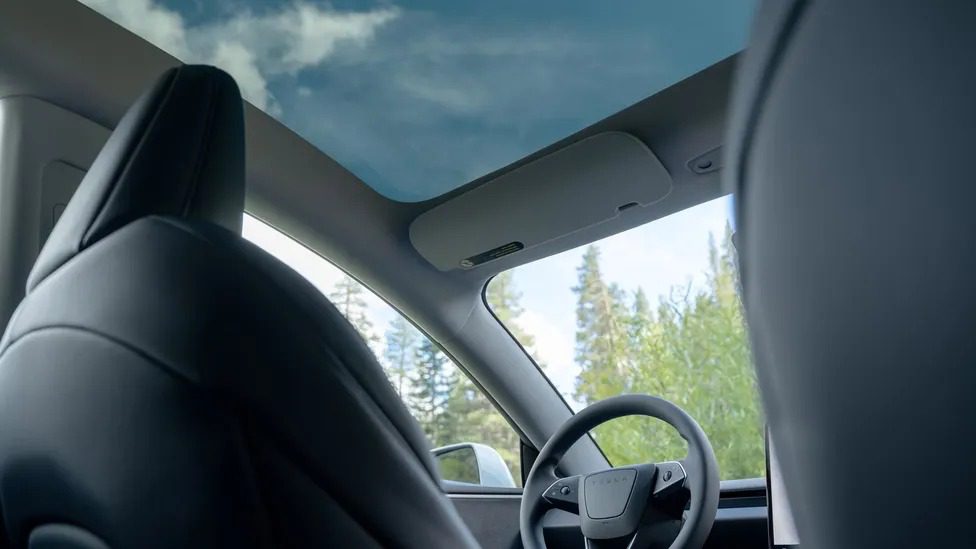 Minimalist interior of Tesla Model 3 Standard showing 15.4-inch touchscreen and cloth seats